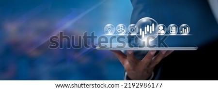 Hand of businessman holding tablet analysis stock market graph growth and increase of chart positive indicators. Hand holding tablet show stock chart on light gray background. copy space banner
