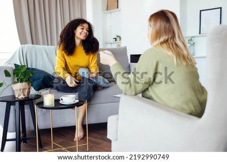 Young african american woman has session with her psychologist. Mixed race female patient talkink to  mental coach in her private consulting room  Royalty-Free Stock Photo #2192990749