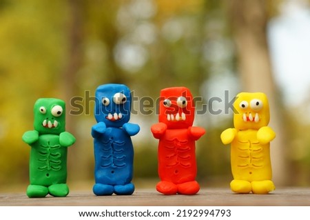 Figures of colorful zombies in close-up. Funny toy monsters made of plasticine.