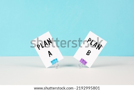 Plan A and B standing on paper, brainstorming for possibilities, making a decision 