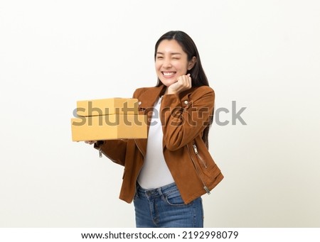 Young excited beautiful asian woman with many parcel cardboard standing on isolated white background. Cheerful female holding lot of parcel box receive from the delivery service Royalty-Free Stock Photo #2192998079