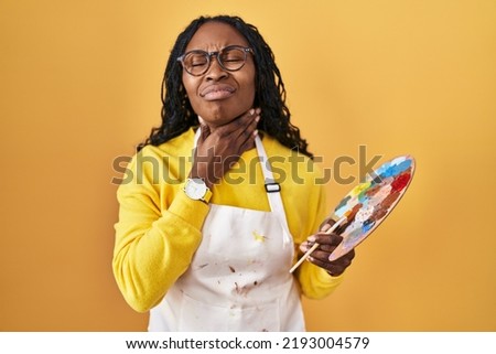 African woman holding painter palette touching painful neck, sore throat for flu, clod and infection 