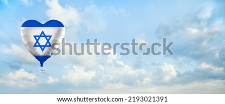 Israeli flag on balloon against sky clouds background. Education, charity, emigration, travel and learning language, Israel concept Royalty-Free Stock Photo #2193021391