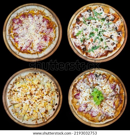 4 pizzas top view on black background