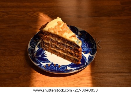 Piece of carrot cake on the coloured plate