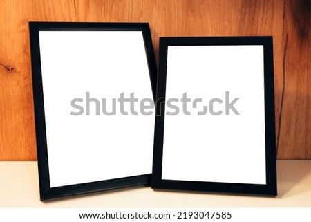 Two blank picture frames on the shelf as mockup copy space for graphic or text