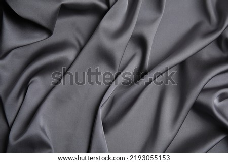 Texture of delicate black silk as background, top view