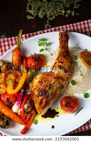 Rustic fried chicken legs with assorted vegetables and rice