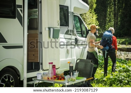 Caucasian Camping Couple Next to Their Class C Motor Home. Preparing For a Hike. Recreational Vehicles Theme. Royalty-Free Stock Photo #2193087129