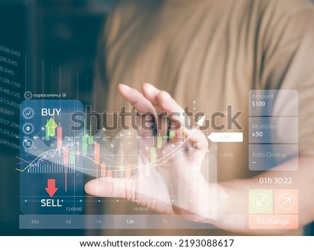 Stock chart analysis or forex currency trading concept. Man using hand to analyze the stock chart, compare benefit or profit of growth chart. Candle-stick chart shows BUY-SELL in virtual screen.
