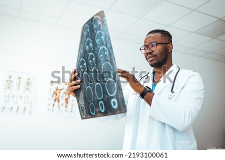 MRI digital x-ray of brain with radiologist doctor oncology working in clinic hospital. Medical healthcare concept. Medical experts studies the EEG condition of the patient. Doctors Examining X-Ray 