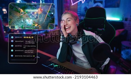 Excited Female Streamer Playing a Video Game Online. Stylish Woman Streaming Gameplay from Her Home, Living Room in Apartment. Followers Engaging Through Interface During Live Broadcast on Internet Royalty-Free Stock Photo #2193104463