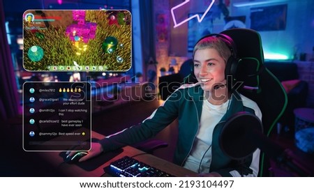 Excited Female Streamer Playing a Video Game Online. Stylish Woman Streaming Her Gaming Progress from Home Living Room Apartment. Followers Engaging Through Interface During Live Broadcast on Internet Royalty-Free Stock Photo #2193104497