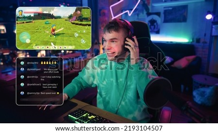 Hyped Streamer Playing a Video Game Online. Stylish Man Streaming MMO Gameplay from Home in Living Room Apartment. Followers Engaging Through Interface During Live Broadcast on Internet. Royalty-Free Stock Photo #2193104507