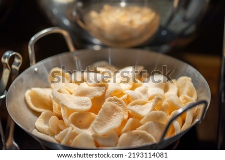 Indonesian crackers for condiment called "Kerupuk". Set in a wok