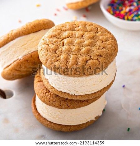 Vanilla ice cream sandwiches with peanut butter cookies stacked on the table