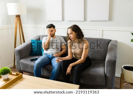 Sad stressed couple with infertlity problems trying to conceive feeling frustrated after getting a negative pregnancy test