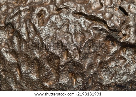 The metal meteorite surface close-up as background.