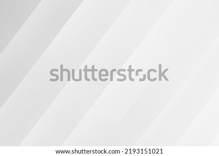 White abstract geometric background with soft light parallel inclined diagonal paper stripes with gradient in simple minimal elegant modern style. Royalty-Free Stock Photo #2193151021