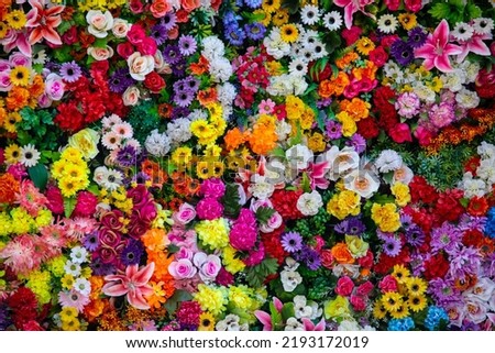 Close-up of a wall of artificial flowers.