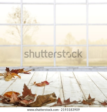 White table background and wondow with autumn leaves 