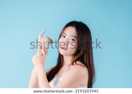 Charming portrait of Asian woman smiling confidence beauty make up on the blue background