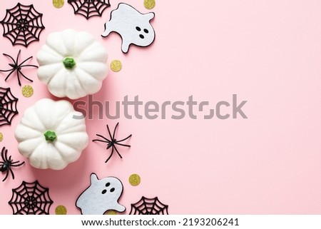 Happy Halloween holiday composition. Top view pumpkins, spiders, ghosts on pastel pink table. Flat lay.