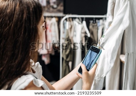 Ecommerce and sell online. Woman taking picture of clothes in the shop. Second hand, Selling used clothes.