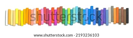 Colorful chalk pastels in an Up and Down Pattern, on white background, arranged as rainbow spectrum 