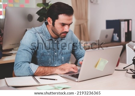  Young businessman with digital laptop in office. Cheerful casual caucasian employee. Portrait of confident modern young businessman hand holding digital tablet.