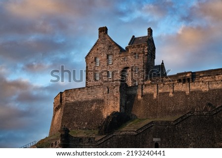 Old medieval Edinburgh castle during summer sunset. Capital of the Scotland. Old massive stone fortification. Historical site on top of the castle rock. Place for many historical Scottish events