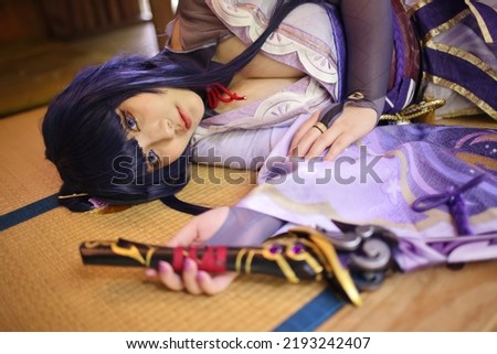 Portrait of a beautiful young woman game cosplay with samurai dress costume sleeping at japanese room