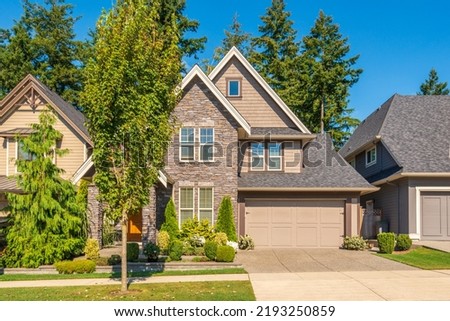 A perfect neighbourhood. Houses in suburb at Summer in the north America. Luxury houses with nice landscape. Royalty-Free Stock Photo #2193250859