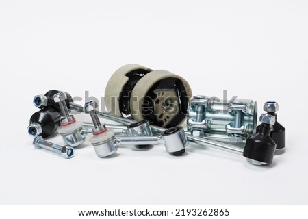 Car spare parts for running suspension repair on a white background.