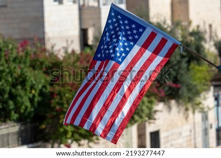 american flag waving in blue sky. American flag on the streets of Jerusalem