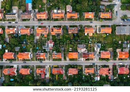 Top view of the city streets, red roofs of houses, urban landscape
