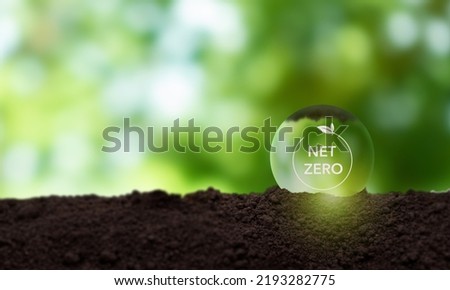 Net zero and carbon neutral concept. Greenhouse gas emissions target. Low carbon emissions. Climate neutral long term strategy. Limit  global warming.  Net zero on green view background. Royalty-Free Stock Photo #2193282775