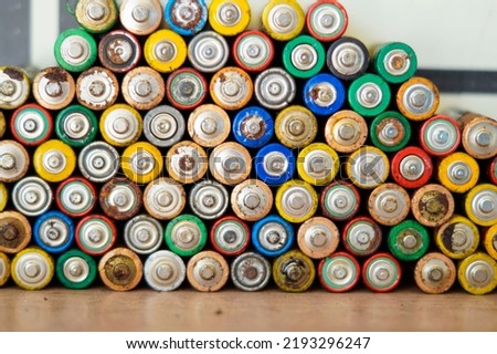 Background of waste batteries.  top view of selection AA batteries. Alkaline battery aa size. Several batteries are next to each other. Many aa batteries. Close up.