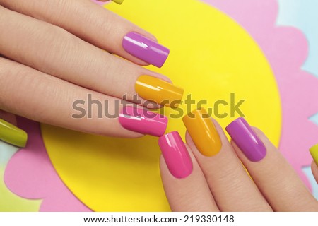 	  Solar manicure colored varnishes rectangular shaped nails. Royalty-Free Stock Photo #219330148