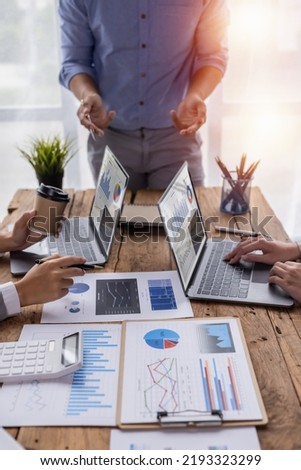 Financial analysts analyze business financial reports on a digital tablet planning investment project during a discussion at a meeting of corporate showing the results of their successful teamwork. Royalty-Free Stock Photo #2193323299