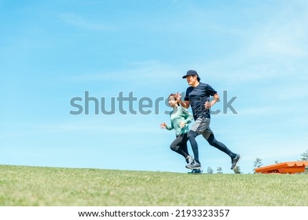Asian men and women running and aerobic exercise Royalty-Free Stock Photo #2193323357