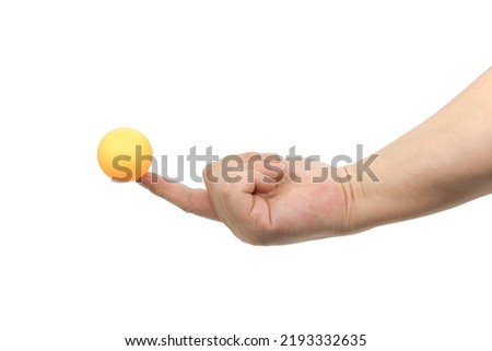 One finger touching an orange ping pong ball, isolated on white background Royalty-Free Stock Photo #2193332635