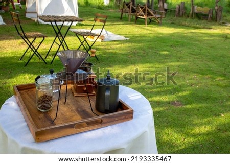 outdoor coffee equipment set Placed on a table with white cloth padding outside the building.