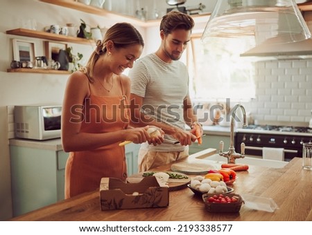 Cooking food, happy and healthy couple preparing a dinner meal in the kitchen together at home. Excited, carefree and joyful lovers doing smiling and laughing while making food or lunch Royalty-Free Stock Photo #2193338577