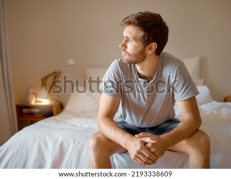 Depression, anxiety, mental health, burnout sad man, thinking and depressed insomnia night. Anxious man stressed, sitting in the bedroom thinking of memories and ideas about the future Royalty-Free Stock Photo #2193338609
