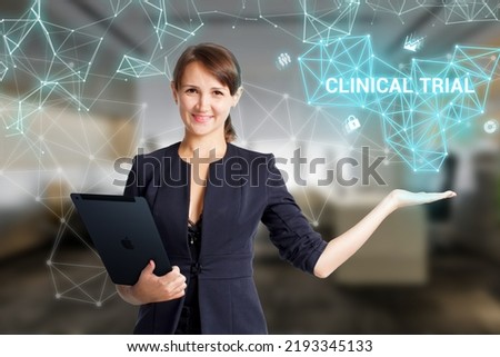Business, Technology, Internet and network concept. Young businessman working on a virtual screen of the future and sees the inscription: Clinical trial