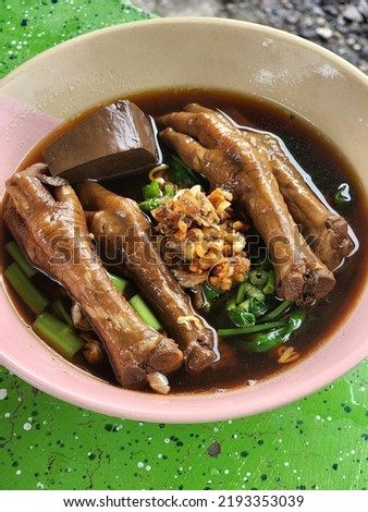 Stewed Chicken feet with noodles soup in bowl, Thai-Chinese food. 
