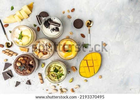 Large collection of Ice cream, delicious gelati with fresh pistachio, chocolate, caramel, melon, mango, chocolate chip sandwich cookies with aromatic vanilla pod on white.