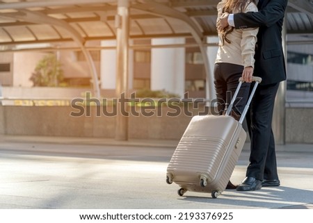 Businesspeople couple lover walking with luggage in business trip. Honeymoon business trip hug together on boarding arrival terminal. Business travel trip holding suitcase at airport couple traveller Royalty-Free Stock Photo #2193376925