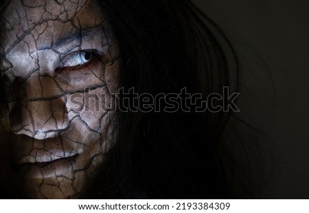 Scary ghost woman. Close up face of Asian woman ghost or zombie horror creepy scary have hair covering the face her eye at abandoned dark tone, female make up zombie broken face, Happy Halloween day